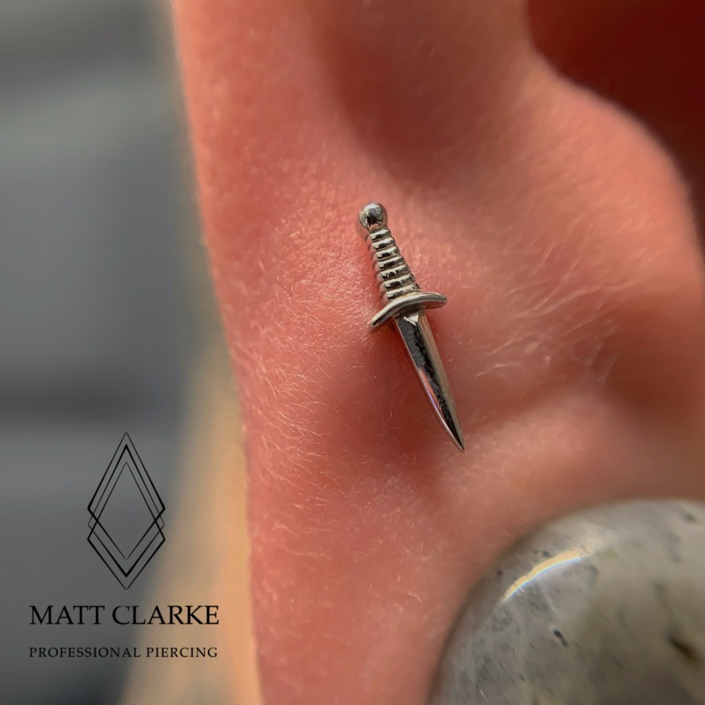 High Lobe Piercing with a 14kt white gold dagger