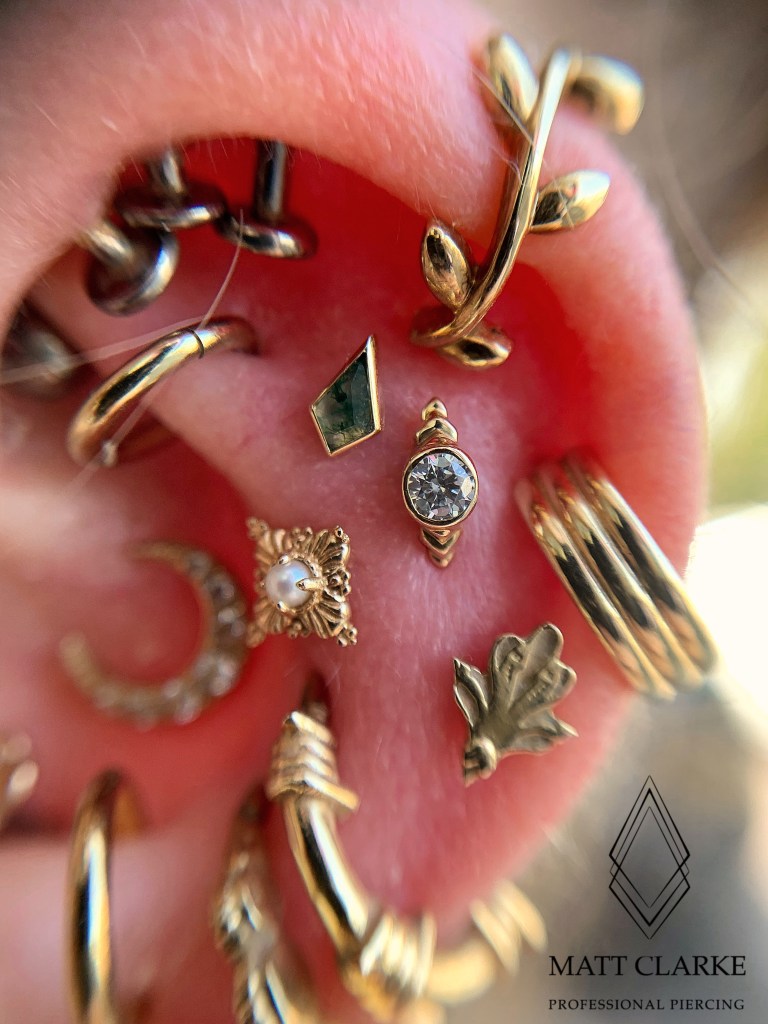 Ear piercings with multiple different locations and jewellery on the ear
